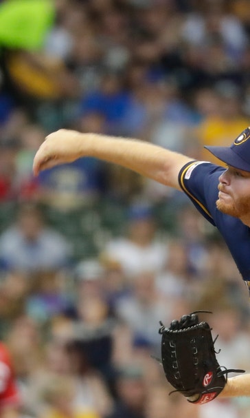 Woodruff strikes out career-high 12, Brewers beat Reds 7-5